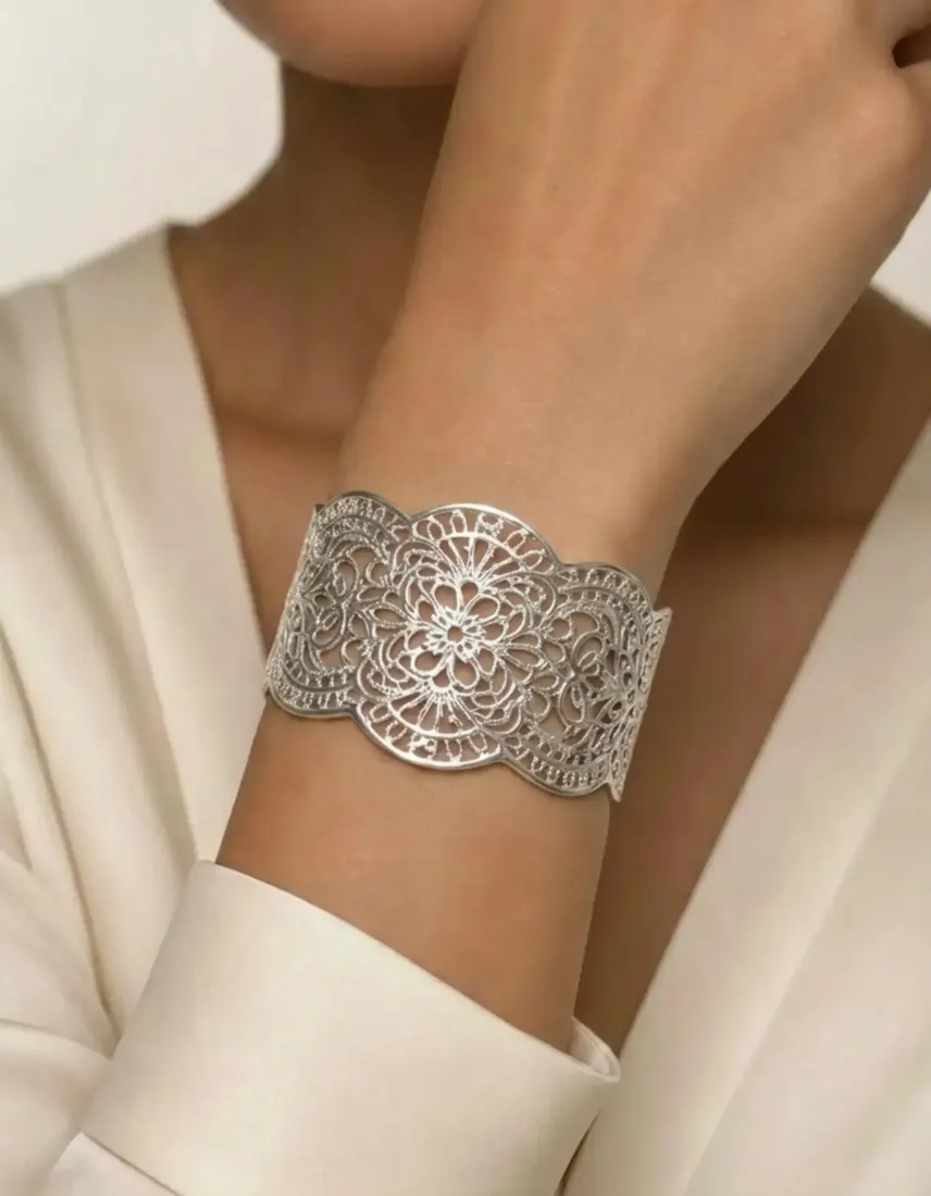 A close-up wrist shot shows a silver filigree cuff bracelet, generated by the Bracelet Generator tool.