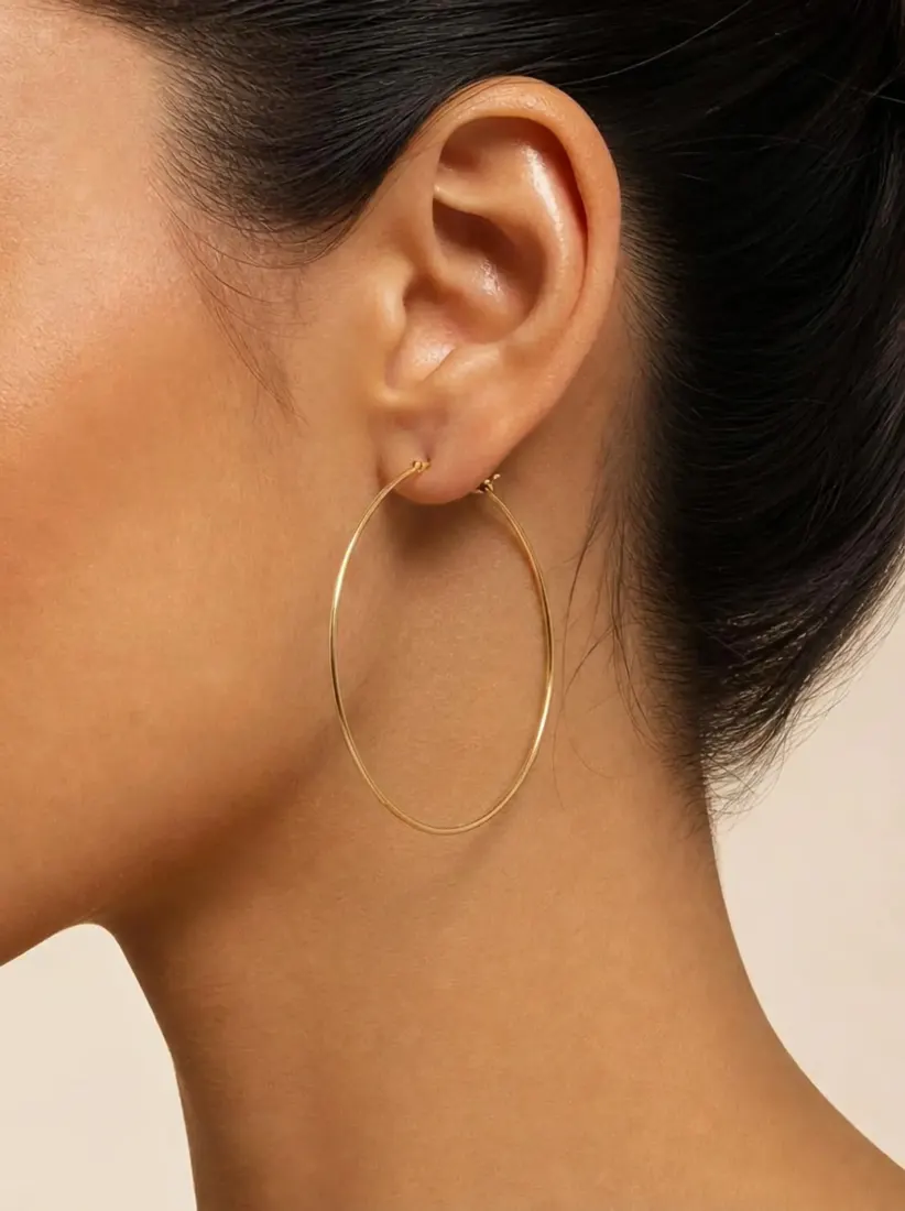 A close-up of an ear shows a large gold hoop earring added by the Earring Generator tool.