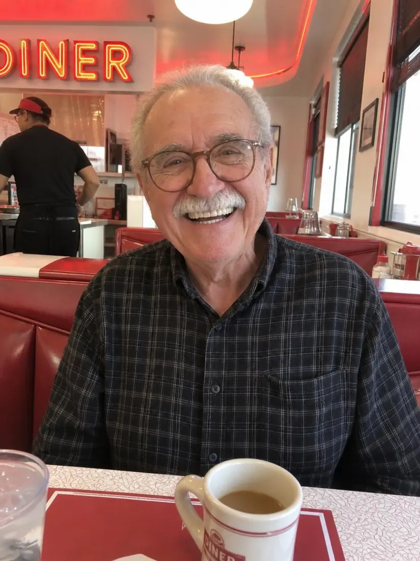 An older man in glasses sits calmly in a diner booth, before the Extreme Sports Filter drops him into whitewater rapids.