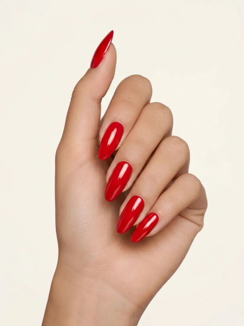A close-up hand shows long glossy red stiletto nails, a manicure created by the Nail Editor tool.
