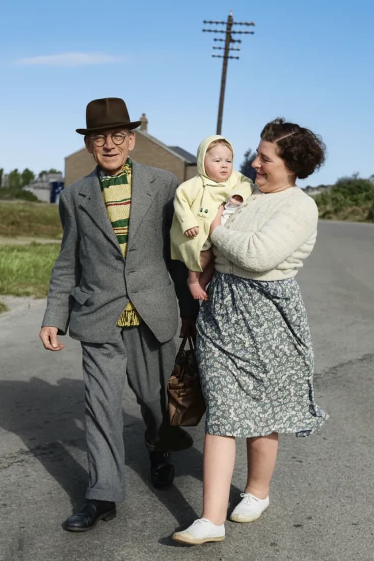 A vintage photo of an elderly man walking with a woman carrying a baby is repaired by the Old Photo Restoration tool.