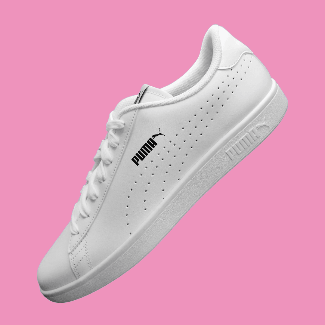 A Puma product photo on a pink background, created with the Background Changer.