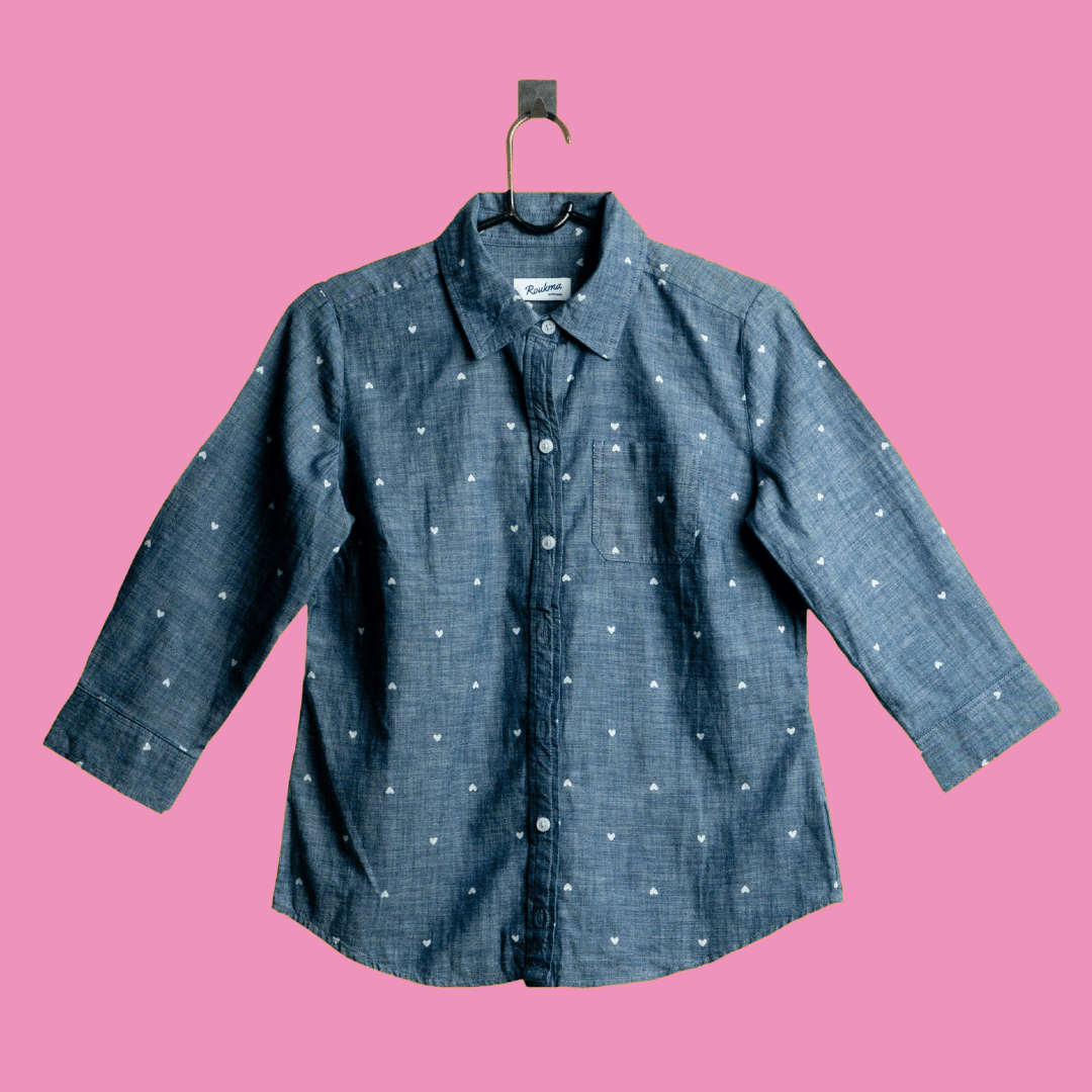 A shirt product photo on a pink background, created with the Background Changer.