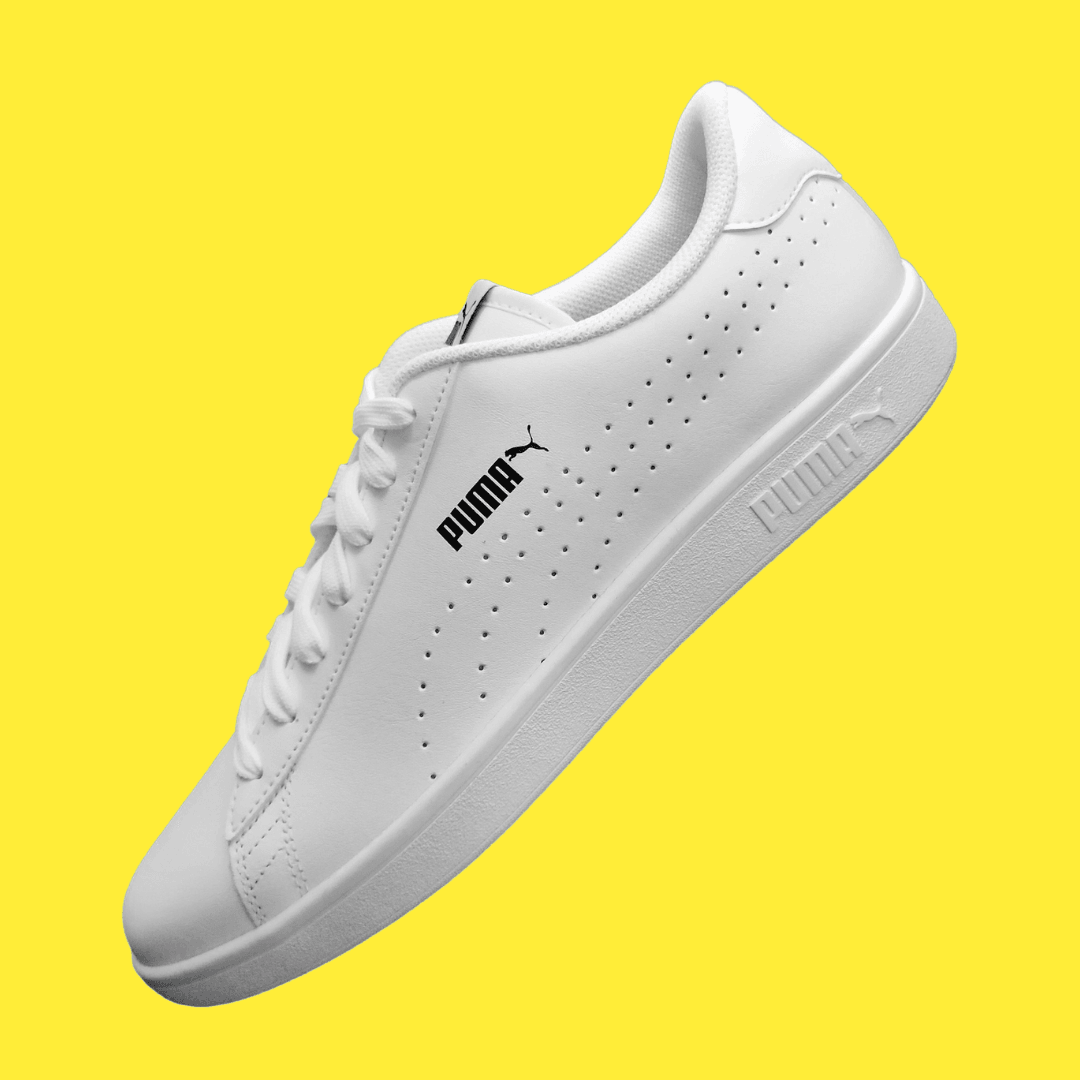 A Puma product photo on a yellow background, created with the Background Changer.